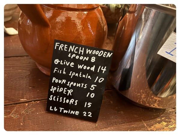 a sign at first bloom advertising kitchen tools